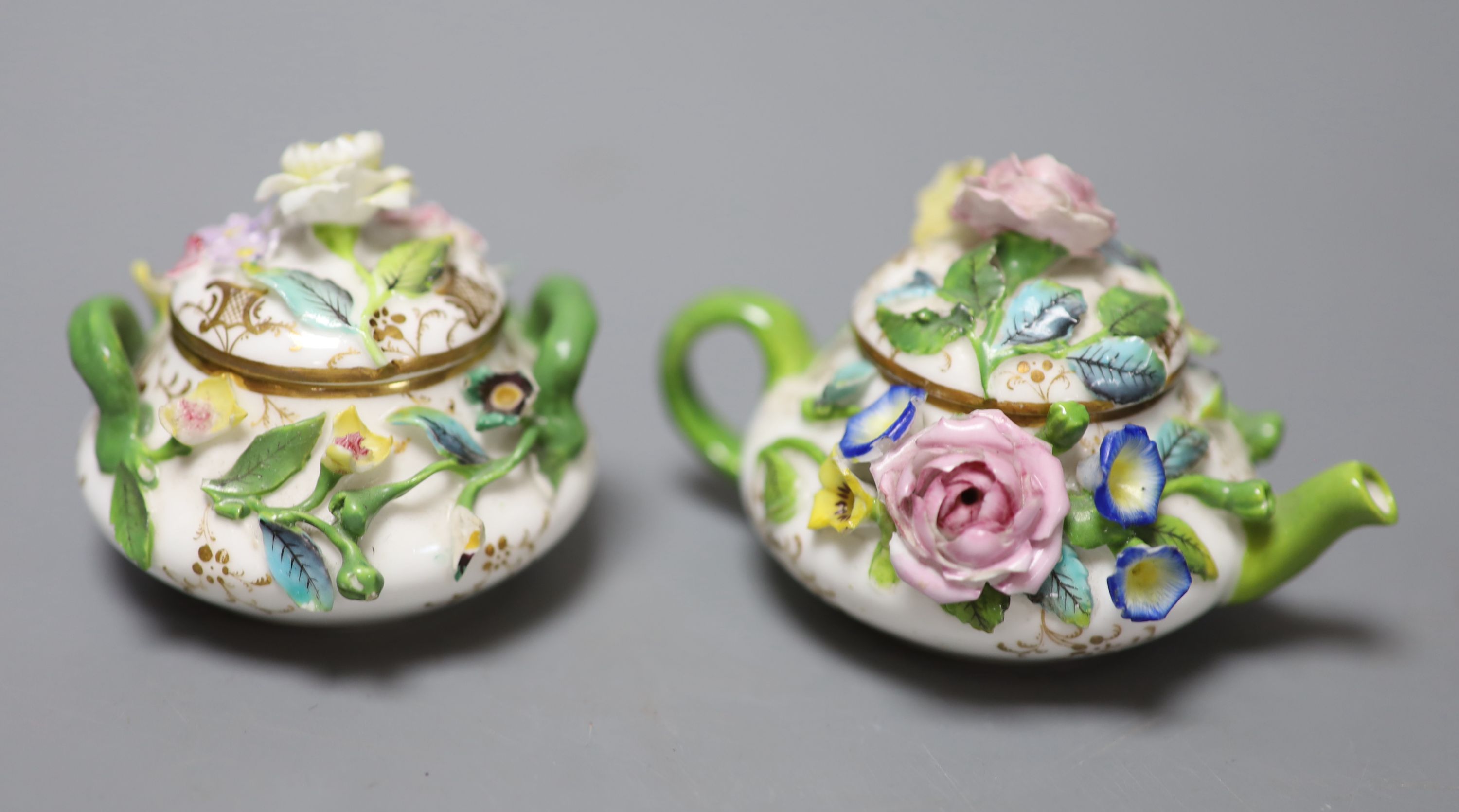 A mid 19th century Minton or Bevington miniature teapot and cover, and matching sucrier and cover, blue cross batons mark to each, tall